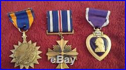 WW11 purple heart, flying cross, air medal, pins, and key chains and dog tags